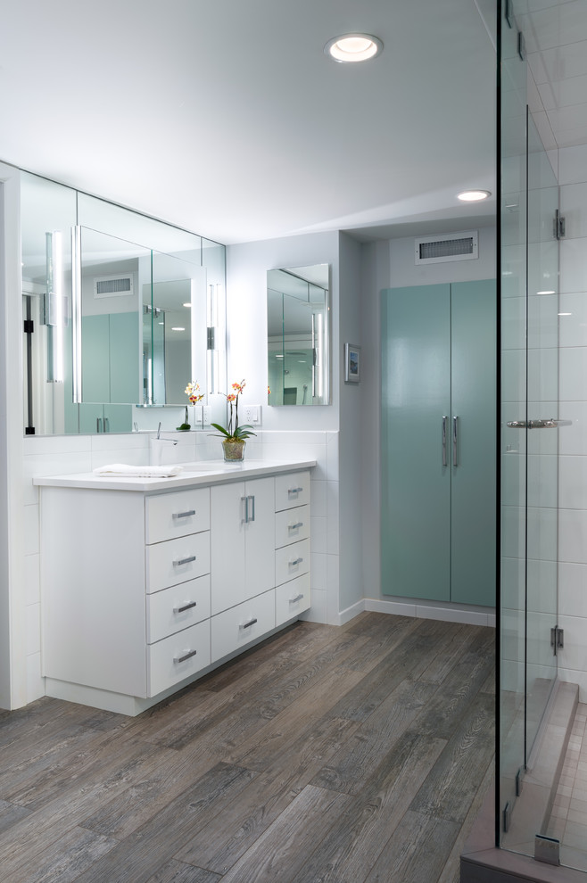 Design ideas for a large contemporary master bathroom in Portland with an undermount sink, flat-panel cabinets, white cabinets, engineered quartz benchtops, white tile, ceramic tile, grey walls and porcelain floors.