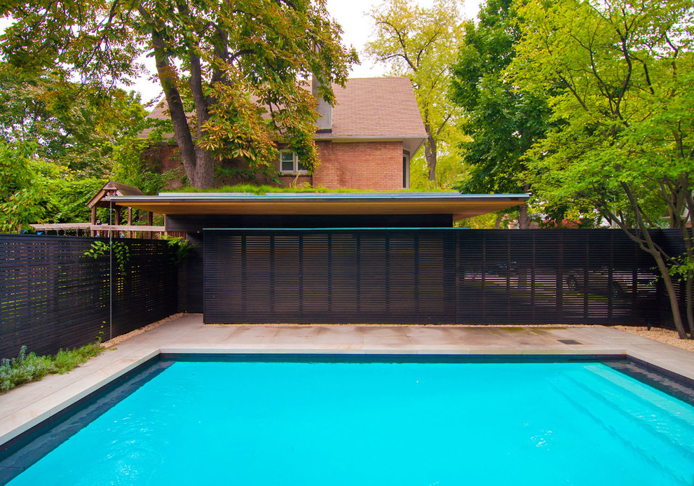Mid-sized modern backyard rectangular pool in Toronto with natural stone pavers.