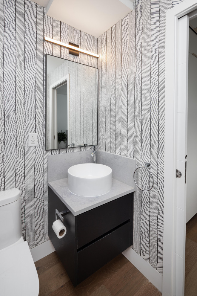 Inspiration för små moderna grått badrum med dusch, med släta luckor, svarta skåp, en toalettstol med separat cisternkåpa, laminatgolv, ett fristående handfat, brunt golv, grå kakel, mosaik, grå väggar och bänkskiva i betong