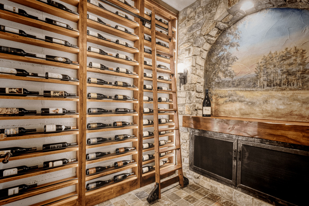 Inspiration for a mid-sized mediterranean wine cellar in Portland with porcelain floors, display racks and brown floor.