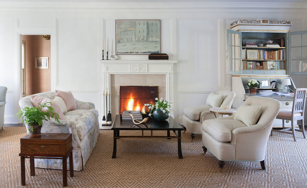 This is an example of a large traditional formal open concept living room in New York with white walls, a standard fireplace and carpet.