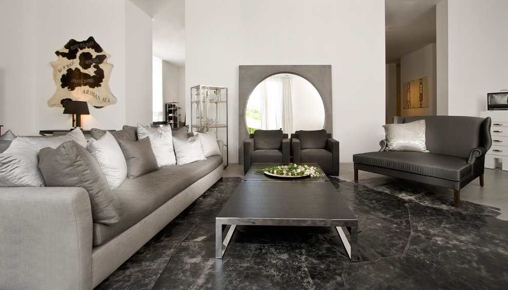 This is an example of a modern living room in Other with white walls and black floor.