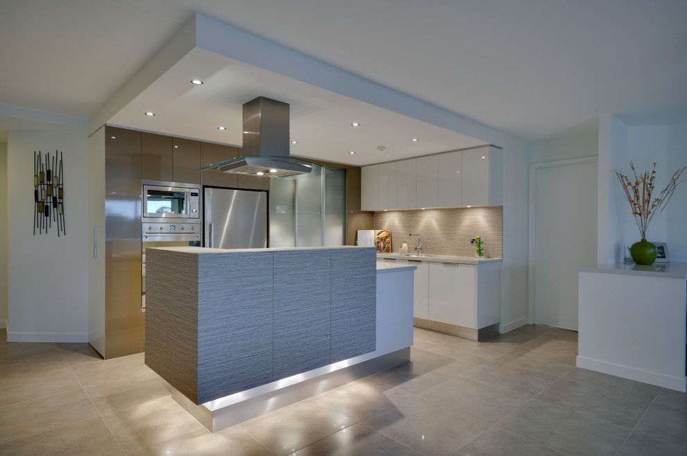 Design ideas for a mid-sized contemporary galley open plan kitchen in Brisbane with flat-panel cabinets, white cabinets, beige splashback, stainless steel appliances, an undermount sink and with island.