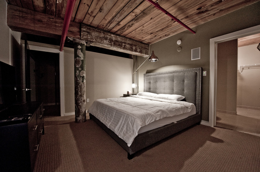 Photo of a mid-sized industrial master bedroom in Atlanta with grey walls, carpet, no fireplace and brown floor.