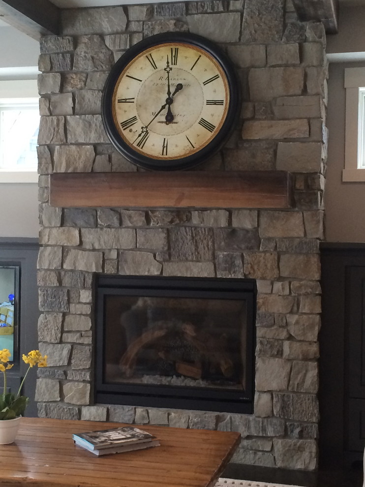 Home design - small rustic open concept carpeted home design idea with a standard fireplace, a stone fireplace and a wall-mounted tv
