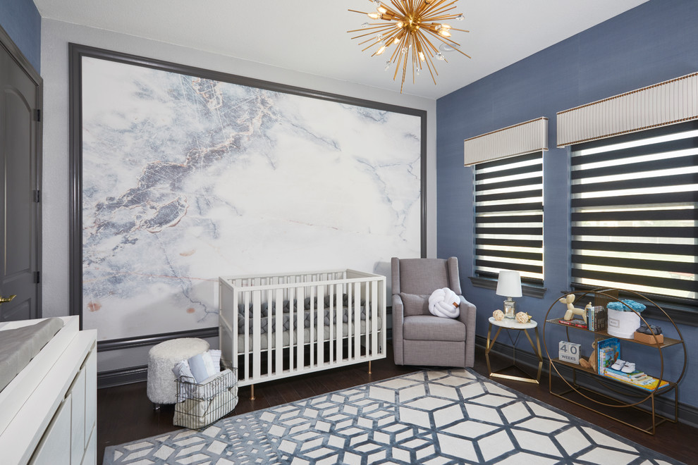 Design ideas for a mid-sized transitional nursery for boys in Austin with blue walls and light hardwood floors.