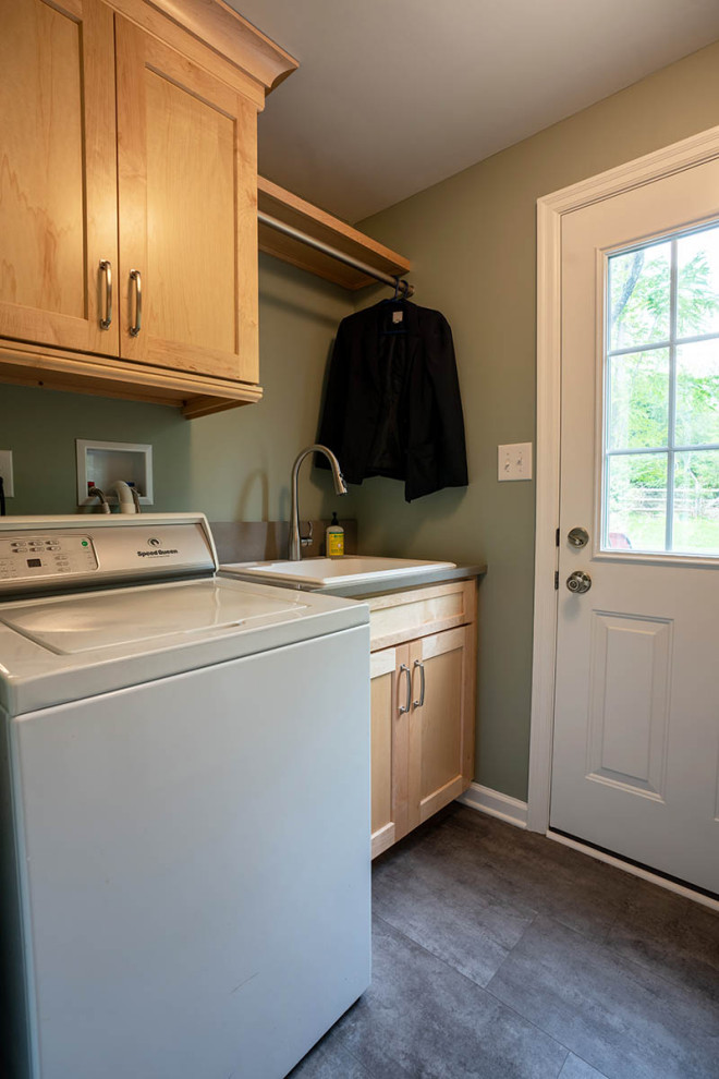 Mid-sized contemporary galley dedicated laundry room in Philadelphia with a drop-in sink, shaker cabinets, light wood cabinets, quartz benchtops, green walls, vinyl floors, a side-by-side washer and dryer, grey floor and grey benchtop.