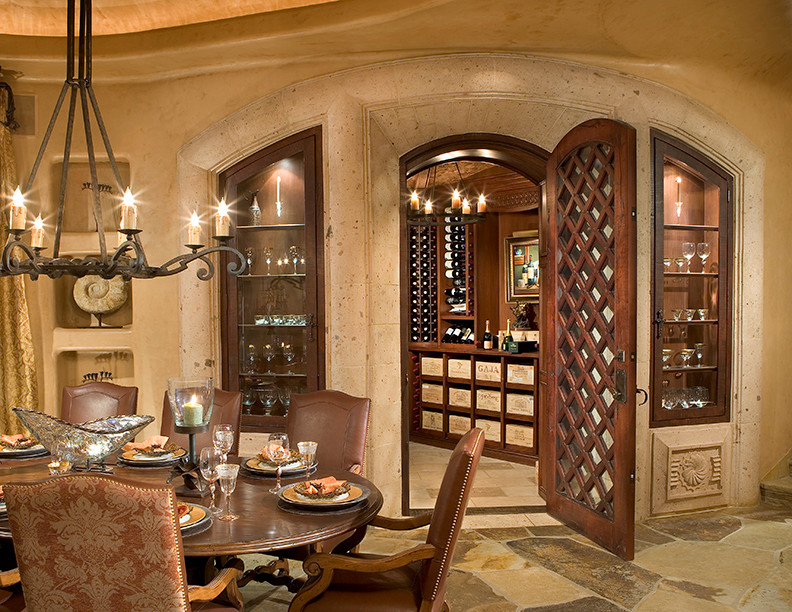 Large wine cellar in Phoenix with limestone floors, display racks and multi-coloured floor.