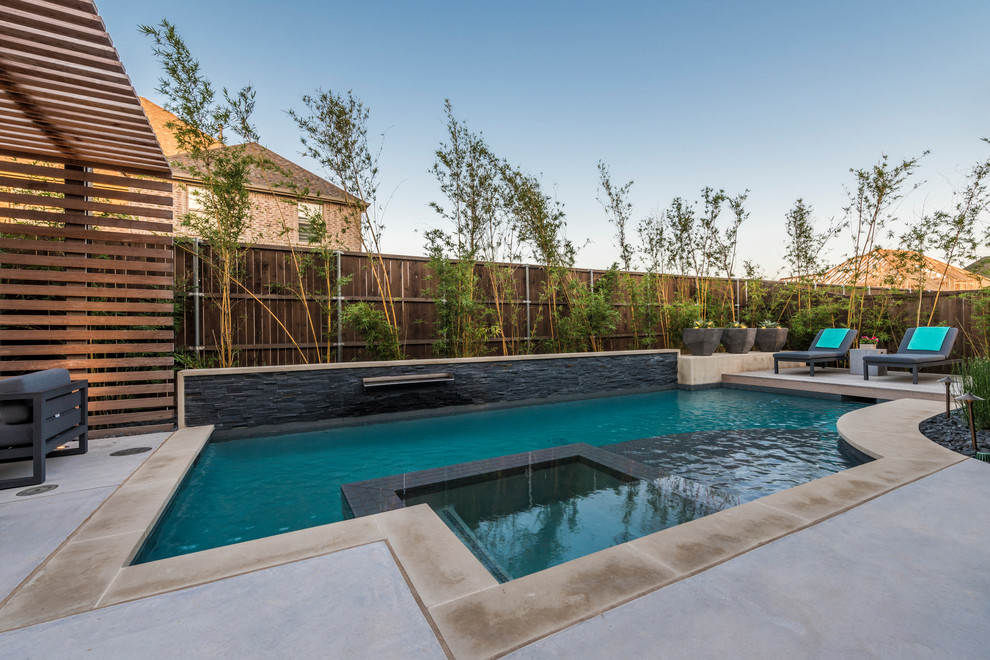 Inspiration for a small transitional backyard custom-shaped pool in Dallas with concrete slab.
