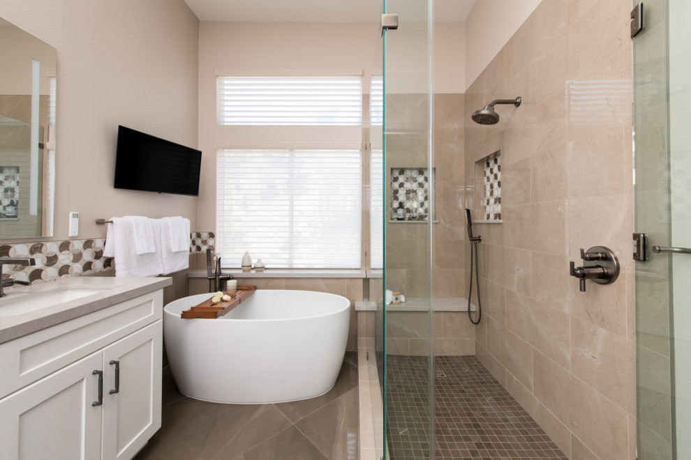 Design ideas for a small transitional master bathroom in Orange County with recessed-panel cabinets, white cabinets, a freestanding tub, an alcove shower, beige tile, porcelain tile, beige walls, marble floors, a drop-in sink, engineered quartz benchtops, grey floor, a hinged shower door, grey benchtops, a shower seat, a double vanity and a built-in vanity.