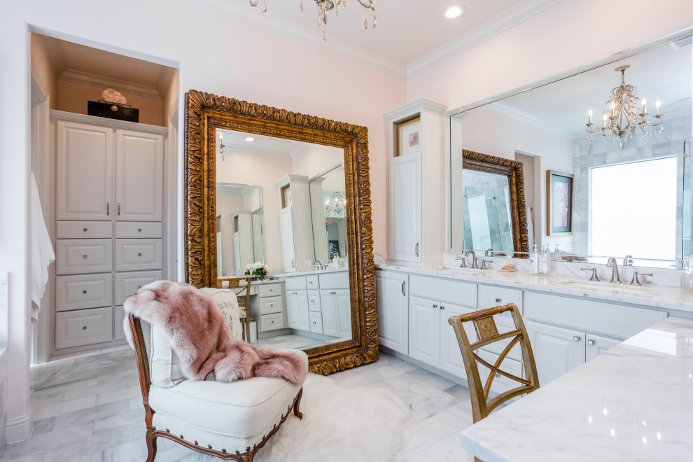 Transitional bathroom in Houston with raised-panel cabinets, white cabinets, pink walls, an undermount sink, grey floor, white benchtops, a double vanity and a built-in vanity.