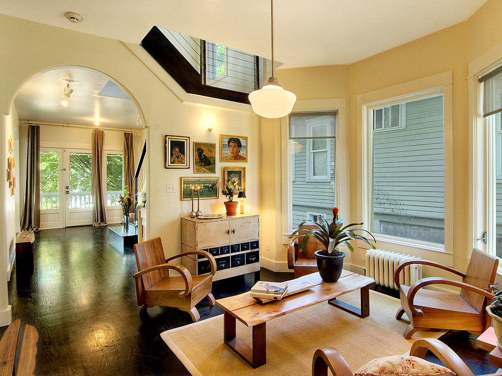 Inspiration for an eclectic family room in Seattle with beige walls and dark hardwood floors.