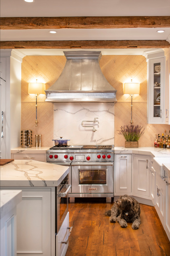 Eat-in kitchen - rustic l-shaped dark wood floor and brown floor eat-in kitchen idea with a farmhouse sink, recessed-panel cabinets, white cabinets, white backsplash, stone slab backsplash, stainless steel appliances, two islands, white countertops and quartzite countertops