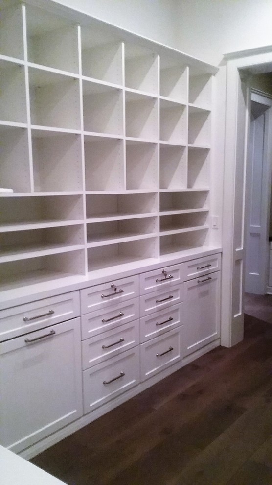 Inspiration for a large arts and crafts gender-neutral walk-in wardrobe in Los Angeles with shaker cabinets, white cabinets, dark hardwood floors and brown floor.