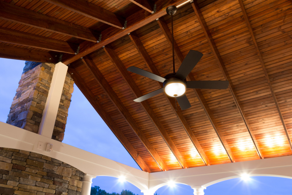 Deck - large transitional backyard deck idea in Baltimore with a fire pit and a roof extension