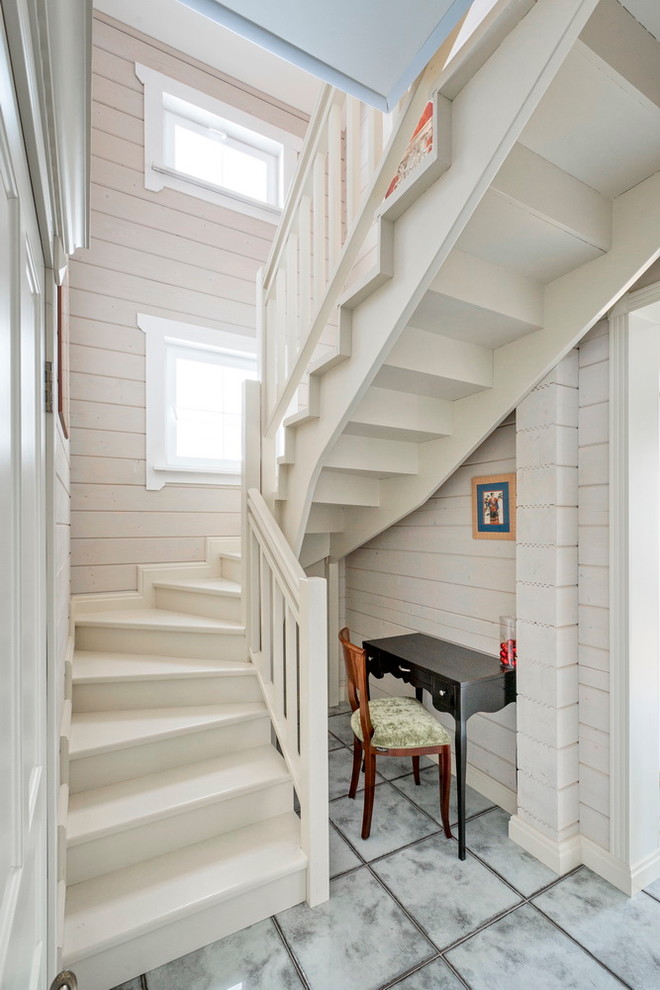 Design ideas for a small country wood u-shaped staircase in Moscow with wood risers.