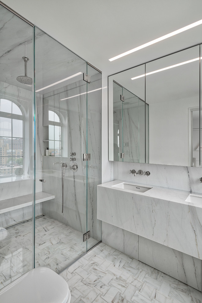 Small contemporary 3/4 bathroom in New York with white cabinets, a freestanding tub, an alcove shower, white tile, stone slab, white walls, terrazzo floors, an undermount sink, terrazzo benchtops, white floor, a sliding shower screen and white benchtops.