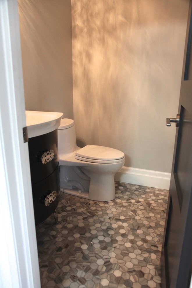 This is an example of a small transitional powder room in Other with flat-panel cabinets, dark wood cabinets, a one-piece toilet, beige walls, mosaic tile floors, an integrated sink, solid surface benchtops and grey floor.