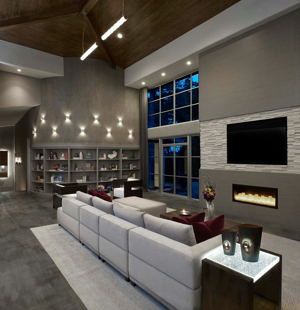 Design ideas for an expansive midcentury open concept family room in Detroit with grey walls, concrete floors, a corner fireplace, a tile fireplace surround, a built-in media wall and grey floor.