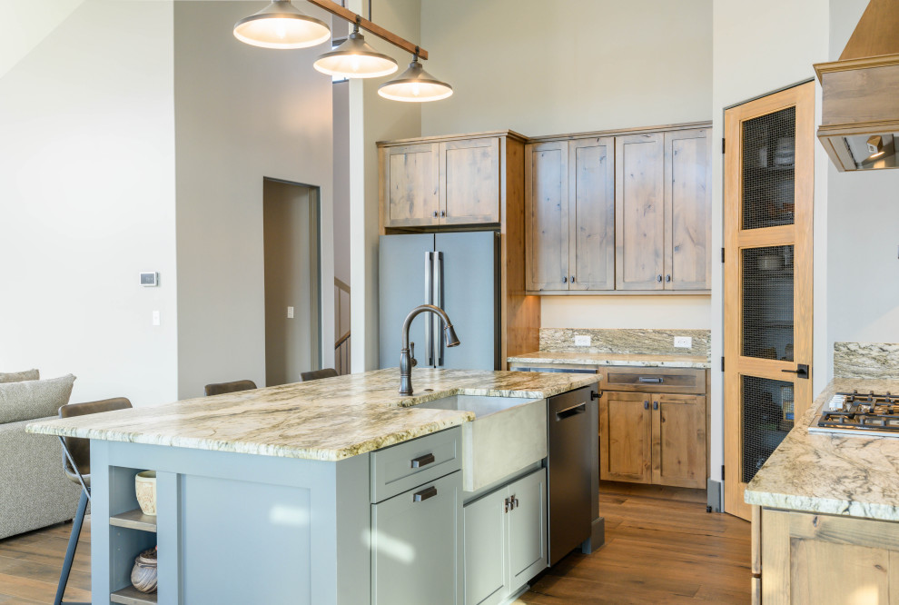 Example of a transitional l-shaped eat-in kitchen design with an undermount sink, shaker cabinets, medium tone wood cabinets, multicolored backsplash, stone slab backsplash, stainless steel appliances, an island and multicolored countertops