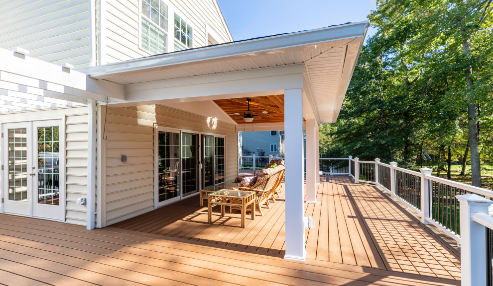 Mid-sized contemporary backyard verandah in DC Metro with with columns, brick pavers and a roof extension.