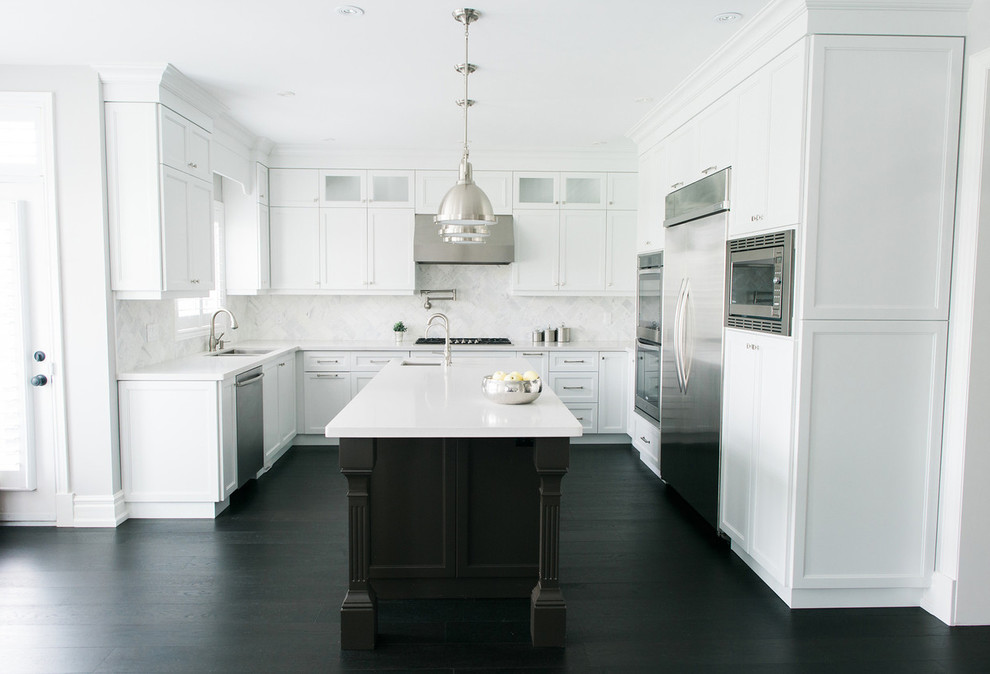 This is an example of a large transitional kitchen in Toronto with shaker cabinets, white cabinets, quartz benchtops, white splashback, mosaic tile splashback, stainless steel appliances, dark hardwood floors and with island.