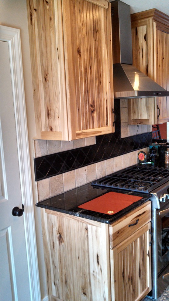 Enclosed kitchen - mid-sized rustic l-shaped porcelain tile enclosed kitchen idea in Richmond with an undermount sink, recessed-panel cabinets, medium tone wood cabinets, granite countertops, beige backsplash, ceramic backsplash, stainless steel appliances, yellow walls and a peninsula