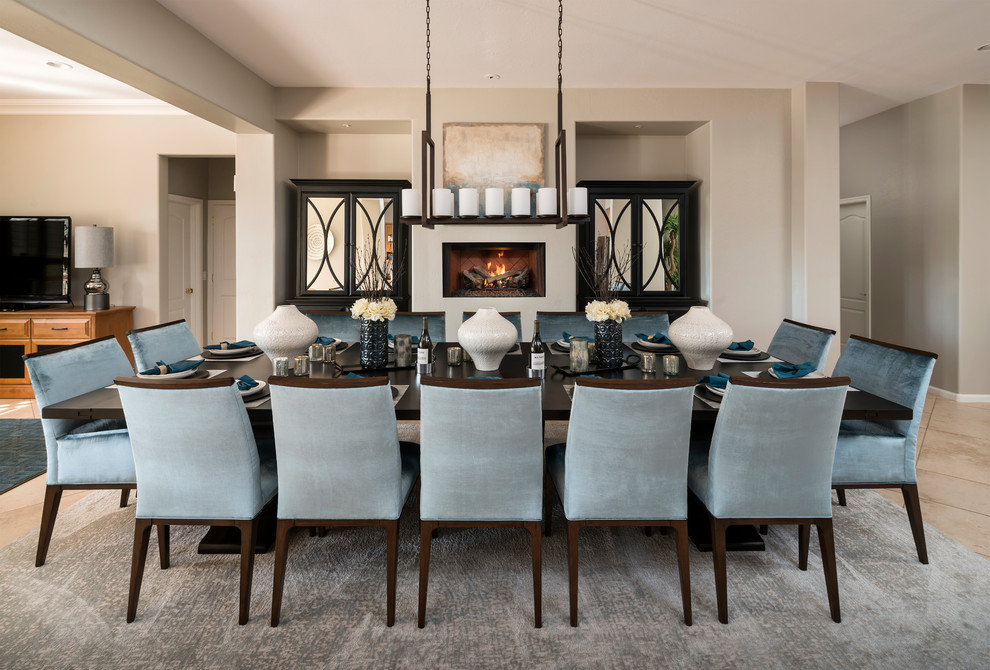 Mid-sized transitional travertine floor and beige floor kitchen/dining room combo photo in Phoenix with gray walls, a standard fireplace and a plaster fireplace