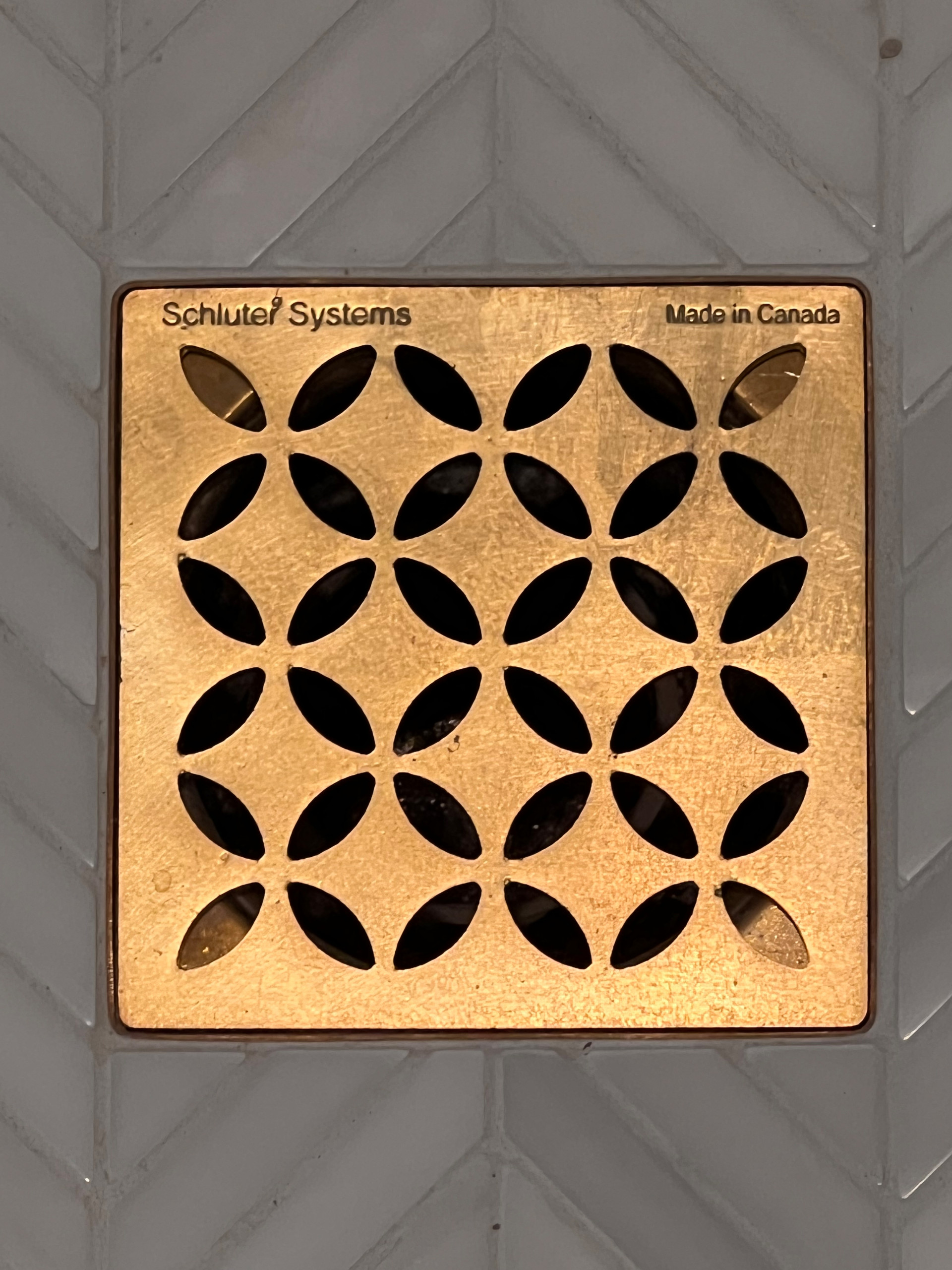 Schluter Drain Holds its Own in the Brass Finish & Mosaic Pattern!