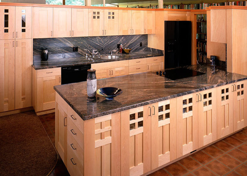 Mid-sized transitional u-shaped dark wood floor and brown floor enclosed kitchen photo with a farmhouse sink, shaker cabinets, light wood cabinets, soapstone countertops, multicolored backsplash, mosaic tile backsplash, stainless steel appliances and an island
