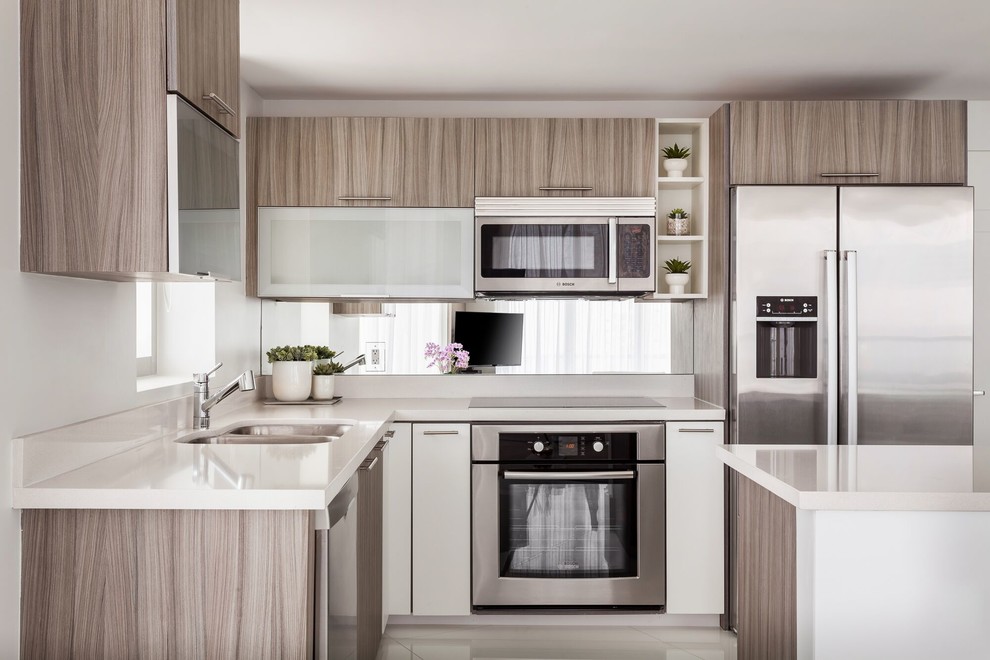 Design ideas for a mid-sized contemporary l-shaped open plan kitchen in Miami with flat-panel cabinets, light wood cabinets, white splashback, stainless steel appliances, white floor, a double-bowl sink, quartz benchtops, porcelain floors and with island.