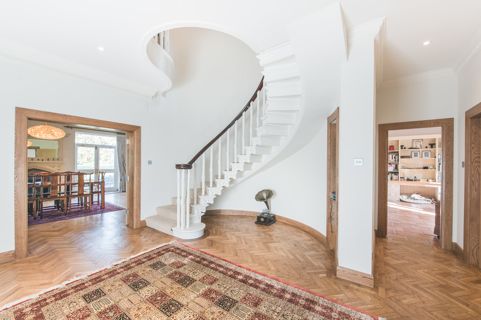 Photo of a traditional carpeted curved staircase in Berkshire with carpet risers.