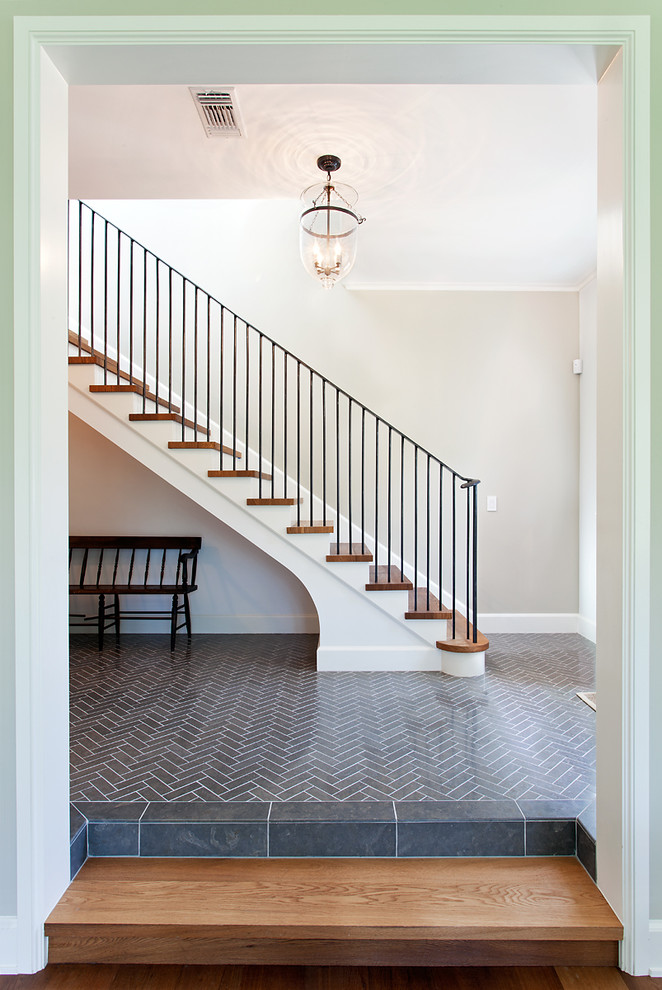Photo of a mid-sized traditional wood straight staircase in Austin with painted wood risers and metal railing.