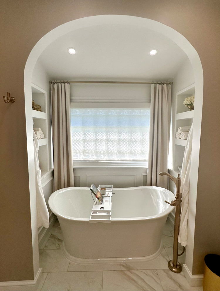 Inspiration for a mid-sized transitional master white tile and marble tile porcelain tile, white floor, double-sink and wainscoting freestanding bathtub remodel with recessed-panel cabinets, white cabinets, a two-piece toilet, brown walls, an undermount sink, quartz countertops, a hinged shower door, white countertops and a built-in vanity