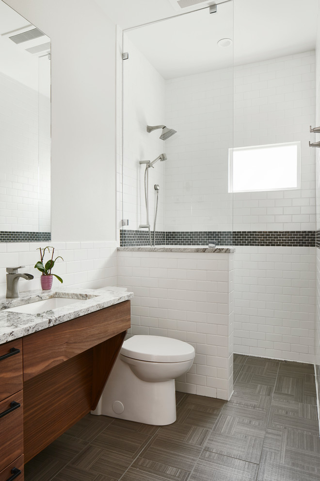 Mid-sized transitional bathroom in Austin with white walls, quartzite benchtops, grey floor, flat-panel cabinets, medium wood cabinets, a curbless shower, white tile, subway tile, an undermount sink, an open shower and grey benchtops.