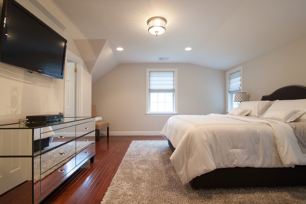 This is an example of a large contemporary master bedroom in New York with white walls and dark hardwood floors.