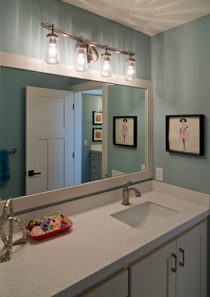 Design ideas for a mid-sized eclectic 3/4 bathroom in Kansas City with recessed-panel cabinets, white cabinets, blue walls, an undermount sink and granite benchtops.