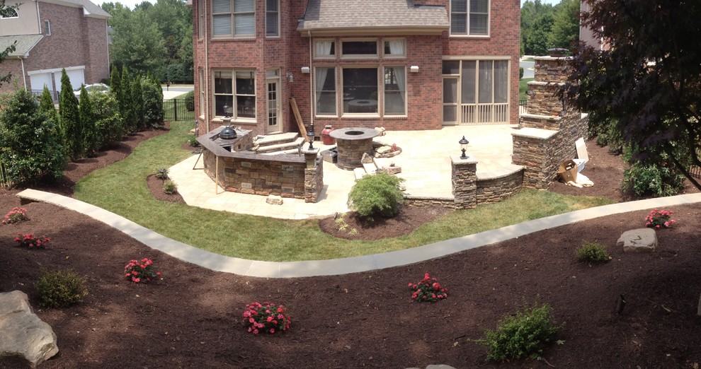 Inspiration for a mid-sized traditional backyard patio in Charlotte with an outdoor kitchen, concrete pavers and no cover.