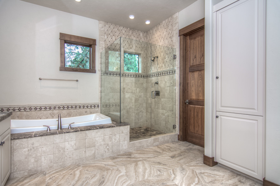 Inspiration for a mid-sized rustic master beige tile drop-in bathtub remodel with white cabinets, white walls, an undermount sink, tile countertops and recessed-panel cabinets