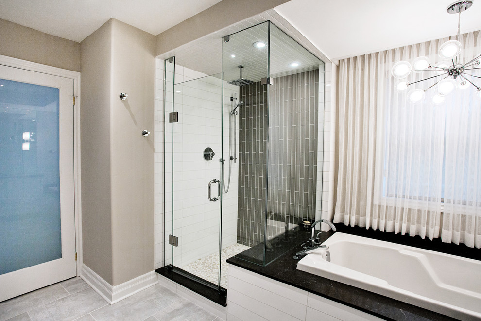 Inspiration for a large modern master bathroom in Toronto with an undermount sink, flat-panel cabinets, light wood cabinets, engineered quartz benchtops, a drop-in tub, a corner shower, a one-piece toilet, gray tile, porcelain tile, beige walls and porcelain floors.