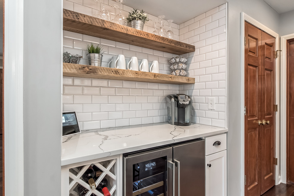 Inspiration for a large transitional u-shaped eat-in kitchen remodel in Columbus with shaker cabinets, quartz countertops, white backsplash and an island
