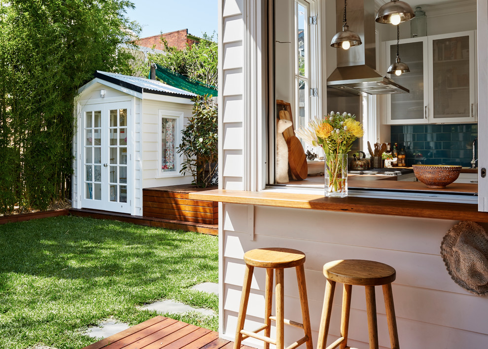 Inspiration for a beach style backyard patio in Sydney with an outdoor kitchen, decking and a roof extension.