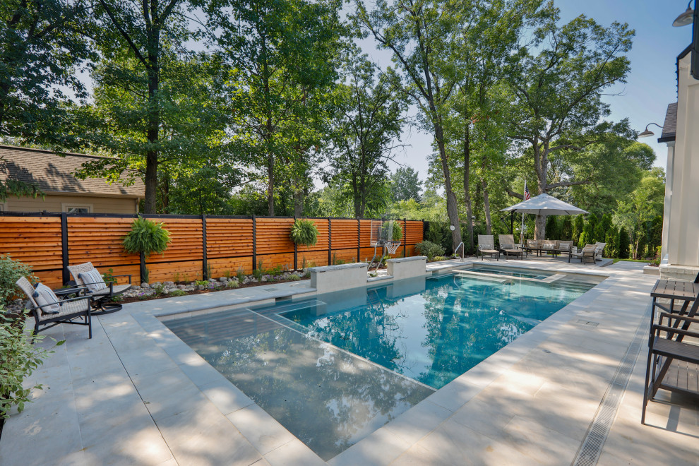 Medium sized classic back private and rectangular lengths swimming pool in Chicago with natural stone paving.