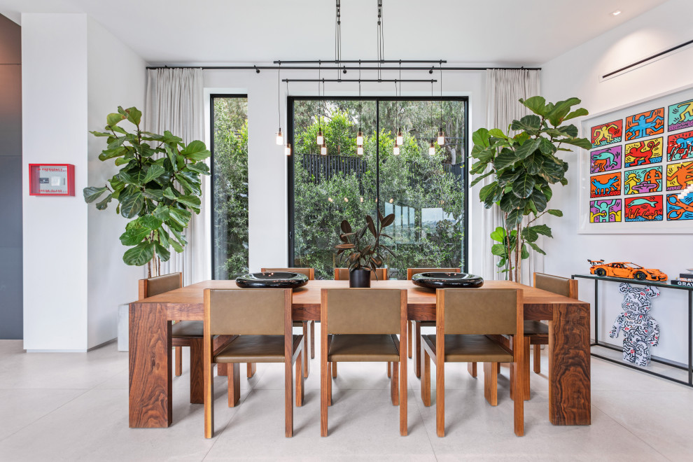 This is an example of a large contemporary dining room in Los Angeles with white walls, porcelain flooring and grey floors.