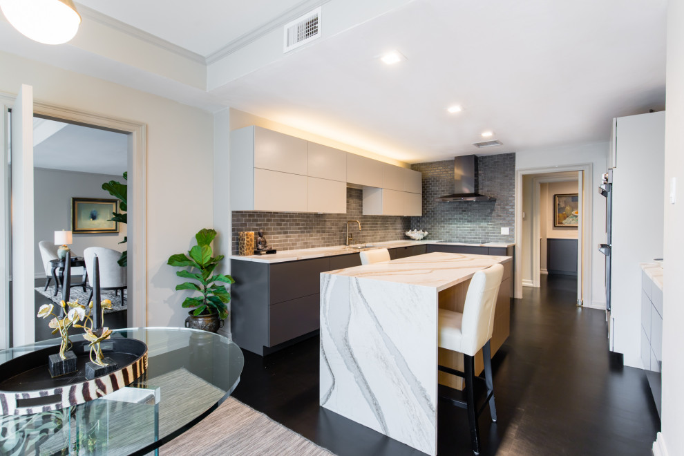 Design ideas for a mid-sized contemporary u-shaped eat-in kitchen in Dallas with an undermount sink, flat-panel cabinets, black cabinets, quartz benchtops, black splashback, subway tile splashback, black appliances, dark hardwood floors, with island, black floor and white benchtop.