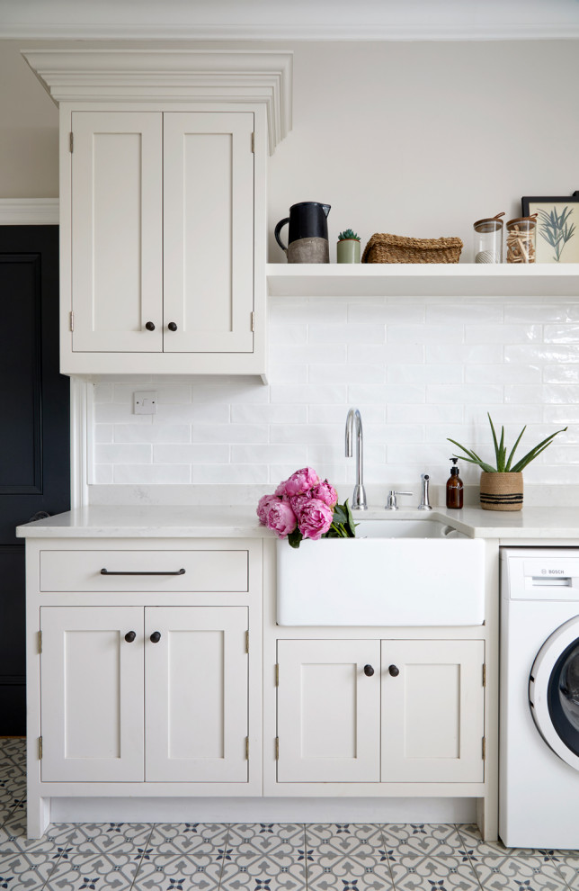Photo of a transitional laundry room in Surrey.