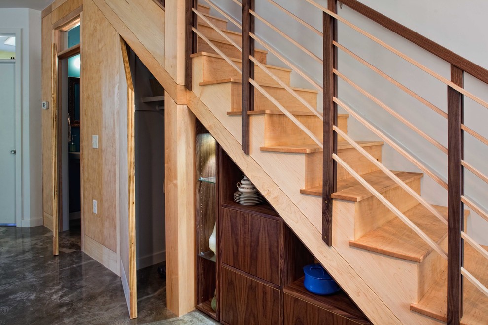 This is an example of a small contemporary wood straight staircase in Charleston with wood risers.
