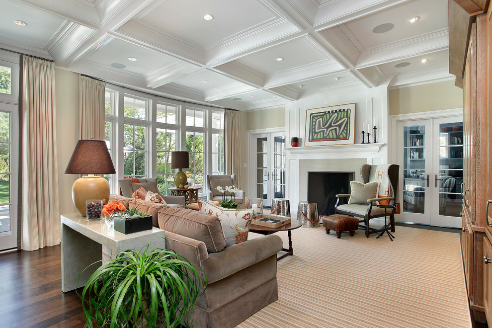 Inspiration for a transitional living room in Chicago with beige walls, dark hardwood floors and a standard fireplace.