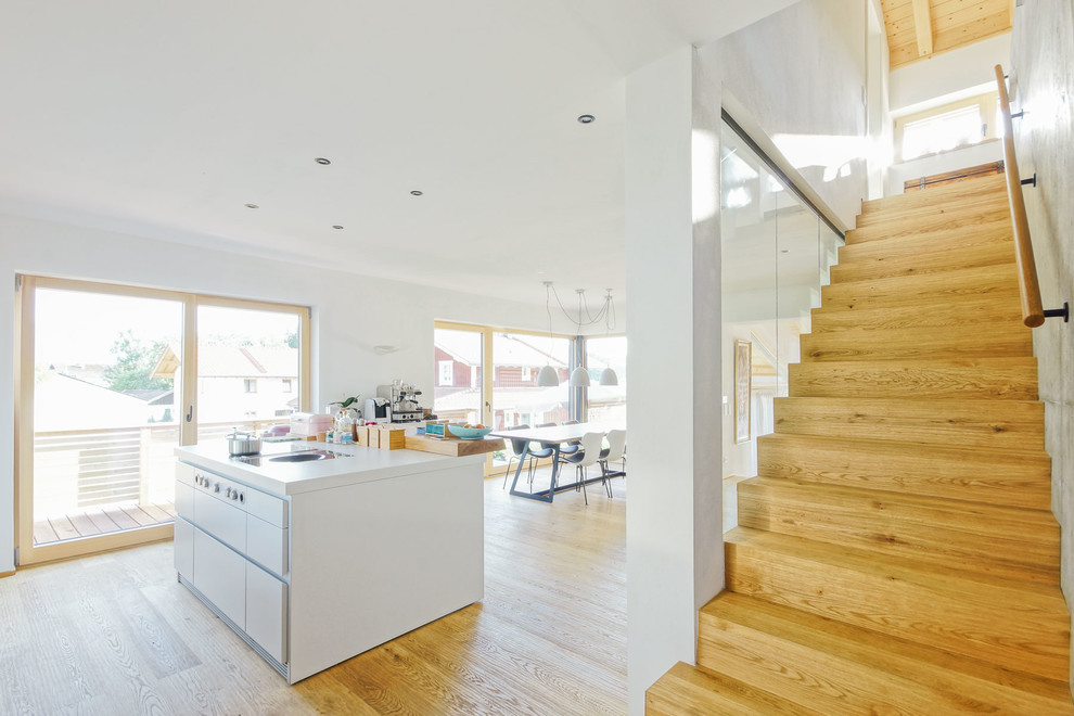 Photo of a mid-sized contemporary wood straight staircase in Other with wood risers and wood railing.