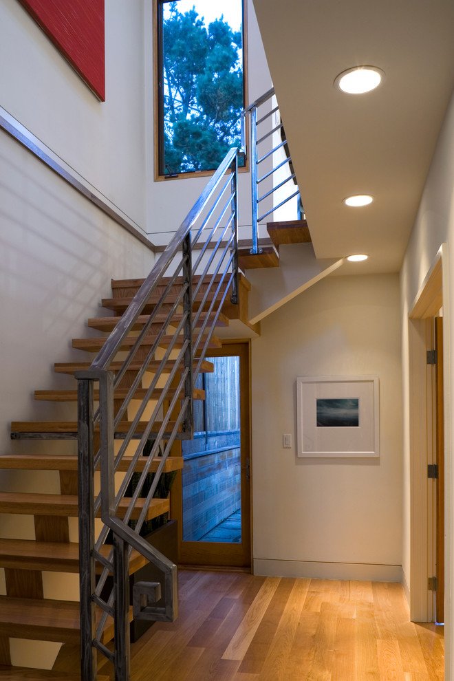 Inspiration for a small contemporary wood floating staircase in San Francisco with open risers.